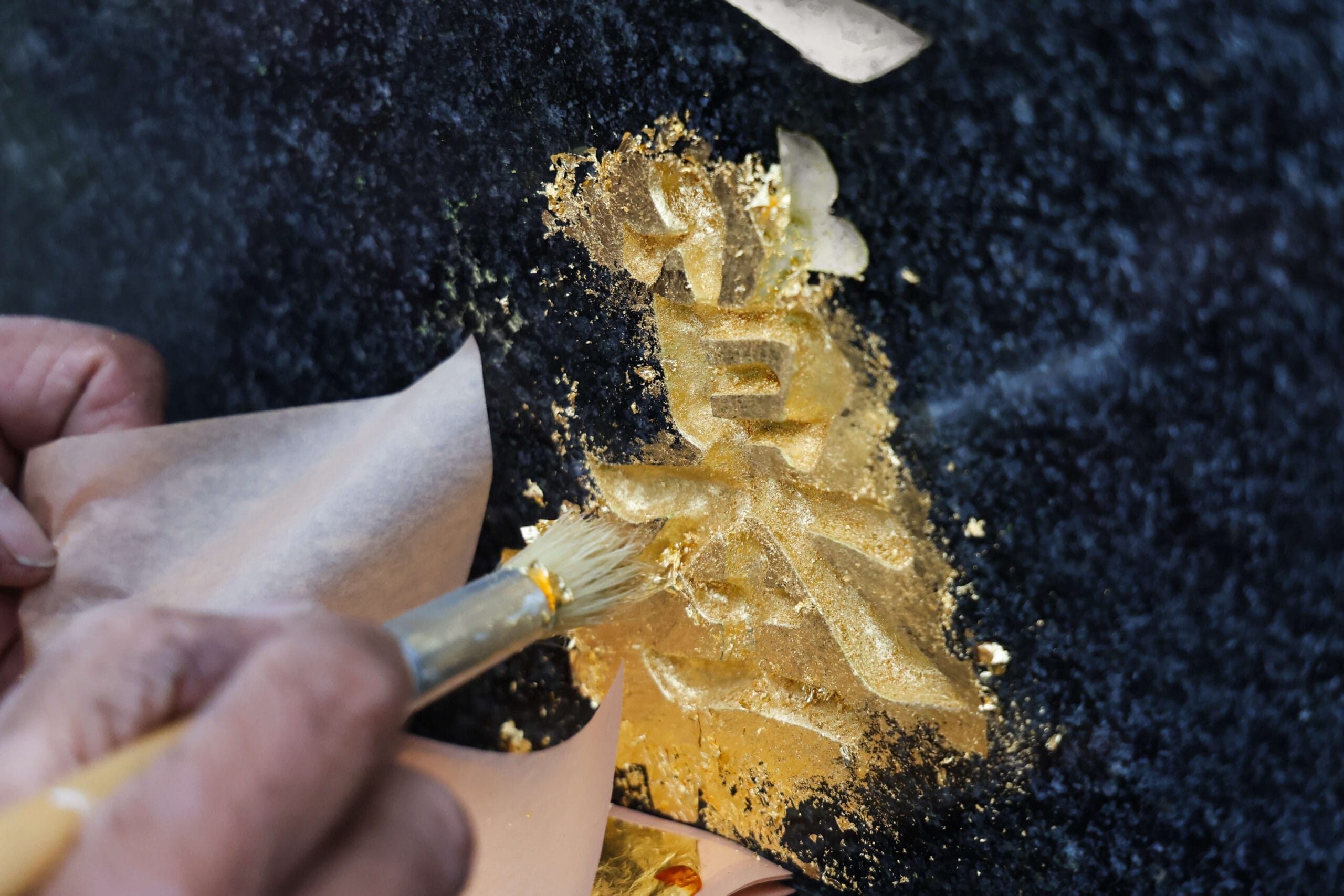 Gold leaf application on stone.